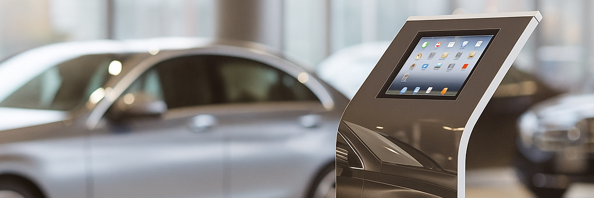 Driving service program enrollment kiosk deployment in automotive service lounge