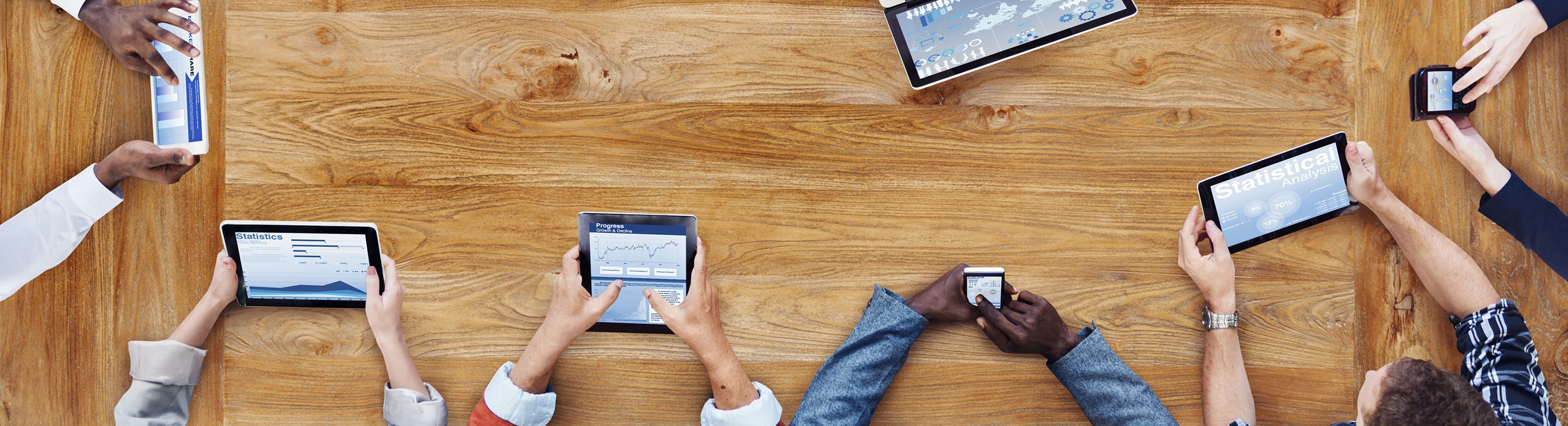 Hands holding different tablets and Ipads