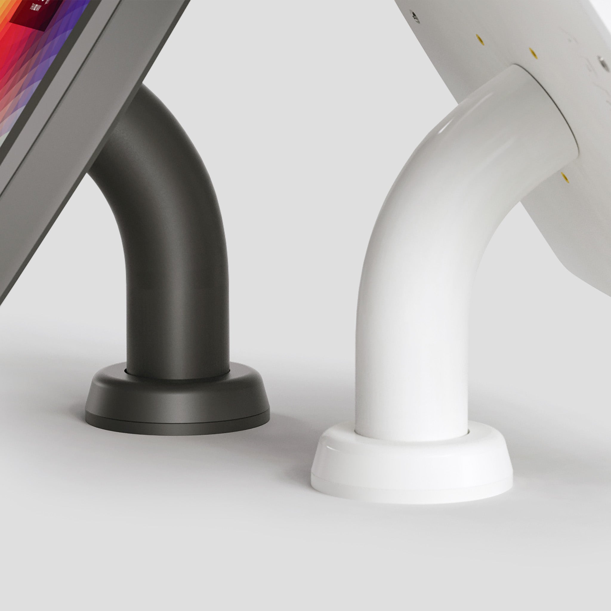 Armodilo Surface Swivel Stands attached to tablet enclosures in black and white